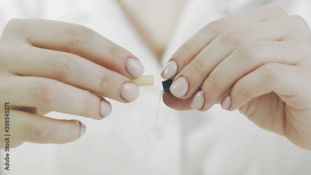 Doctor is opening medical capsule