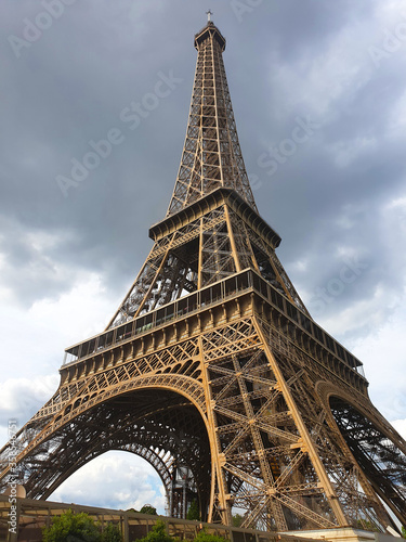 Stunning Eiffel Tower view with dark clouds. Closeup capture aiming to show different aspect of Eiffel tower in bad wheather.