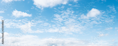 Panoramic blue sky background with small white fluffy clouds, high resolution panorama © Thomas Dutour