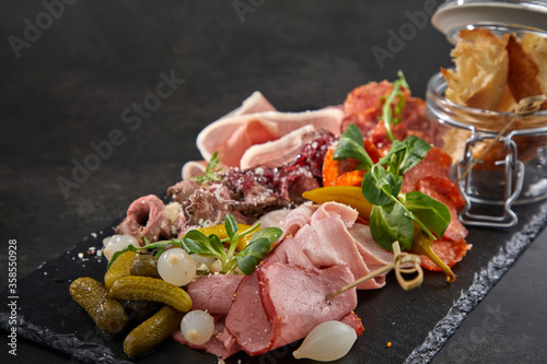 meat appetizers on the black background photo