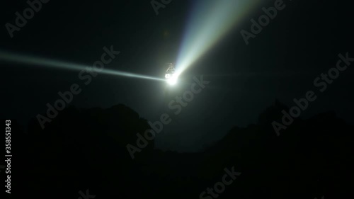 Very powerful Creach lighthouse illuminated in evening, Ushant island, France