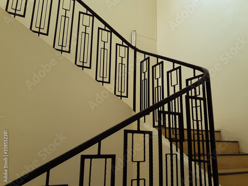 spiral staircase in a modern building.Stairway between floors with beautiful metal railings to prevent falls. Within the old building in Thailand