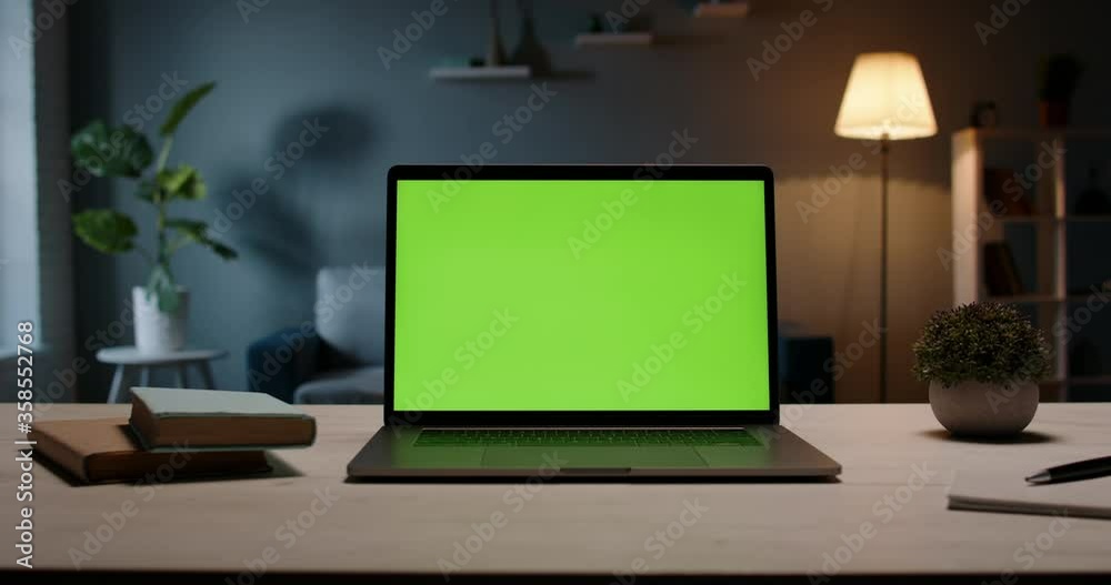 Close up shot of modern chroma key green screen laptop computer set up for work on desk at night - remote work, technology concept 4k video template Close up shot of modern chroma key green screen laptop computer set up for work on desk at night - remote work, technology concept 4k video template