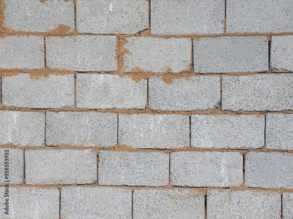 Gray exposed concrete brick wall textured background Gray exposed concrete brick wall textured background