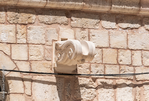 Carved in white marble and decoratively decorated gutter in the wall of the Church of the Holy Sepulchre in the old city of Jerusalem, Israel