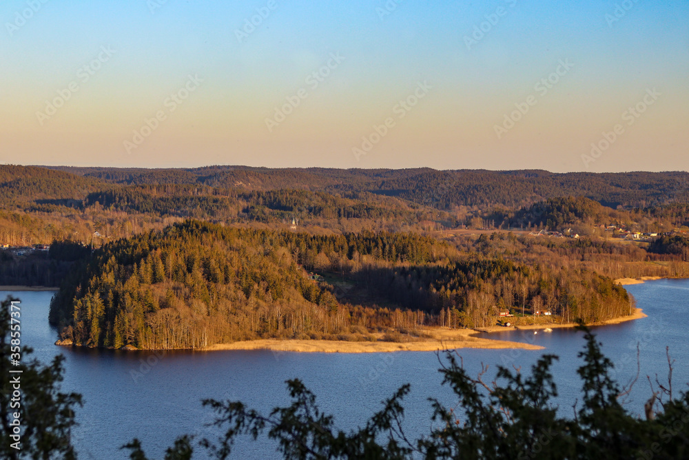 Stunning view from a hill over a lake and a peninsula, a forest landscape in Sweden