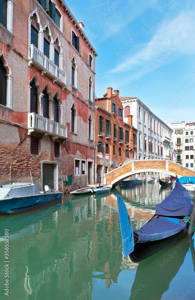 Italy. Venice's beautiful landscape with typical old houses of Venetian architecture, curved bridges and gondolas in the canal