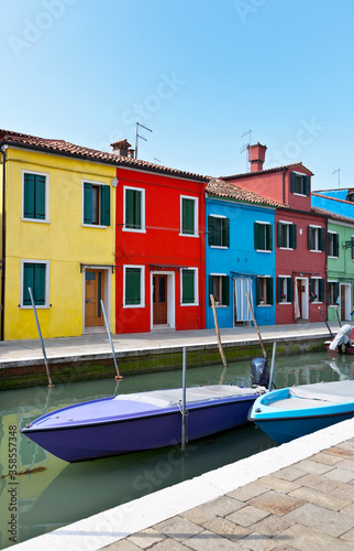 Italy. Venice. Beautiful cityscape with boats on the canal and colorful houses typical of the island of Burano
