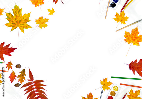 Autumnal maple leaves  red leaves oak  acorns  leaves staghorn sumac  pencils  brush  paint on white background with space for text. Top view  flat lay