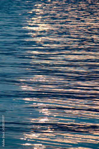 Sunset light reflecting on rippled water surface