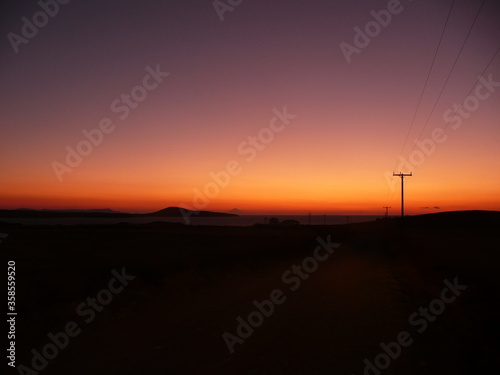 Greek sunset with power lines © Thomas