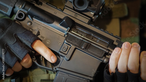 Abstract closeup of security contractor holding an AR15 Rifle