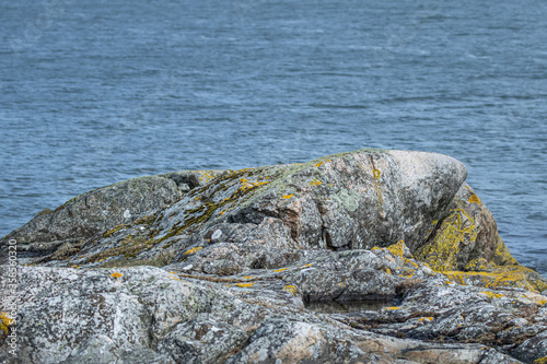 Granite rock formation on Swedish west coast with sea background photo
