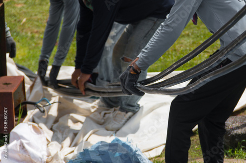 Workers are moving cables in construction sites.