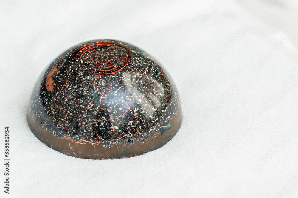 Close up of hot black massage stone sitting on white towel in spa. Close up of hot black massage stone sitting on white towel in spa.