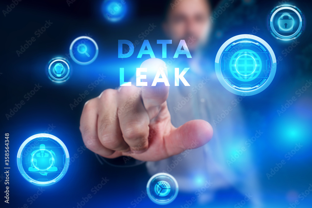 Fototapeta premium Business, Technology, Internet and network concept. Young businessman working on a virtual screen of the future and sees the inscription: Data leak