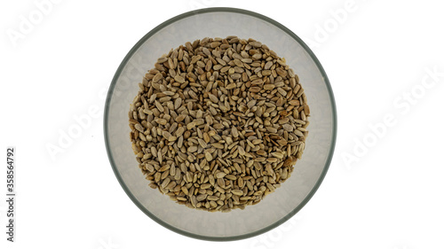 peeled sunflower seeds in a plate on a white background