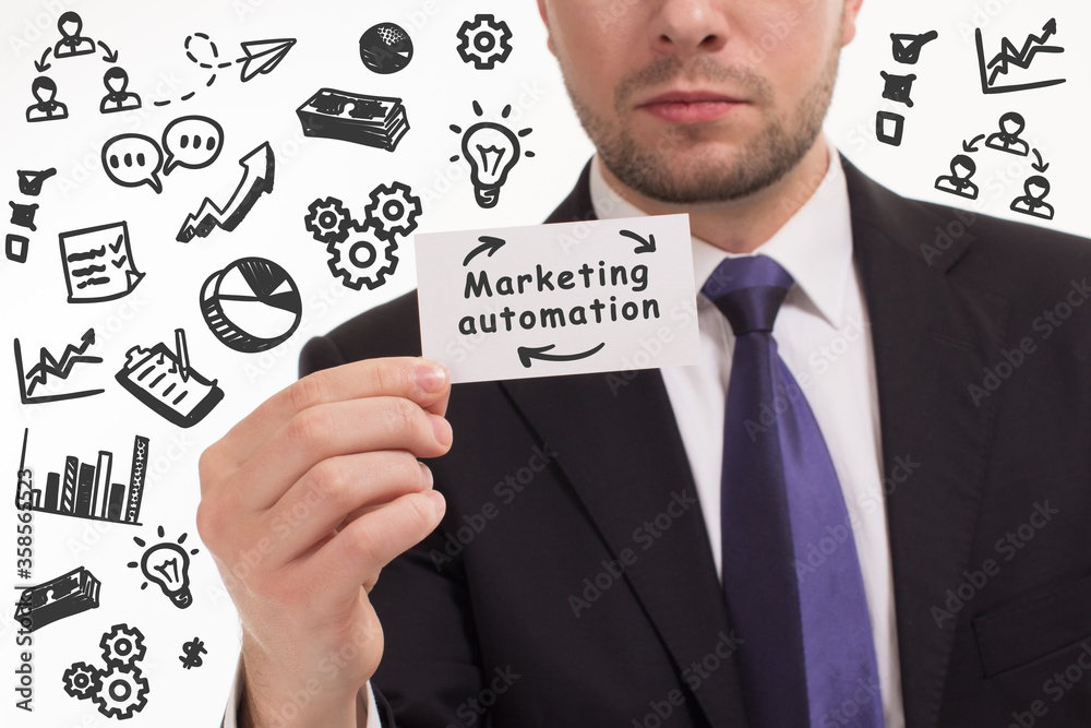 Business, technology, internet and network concept. Young businessman thinks over the steps for successful growth: Marketing automation Business, technology, internet and network concept. Young businessman thinks over the steps for successful growth: Marketing automation