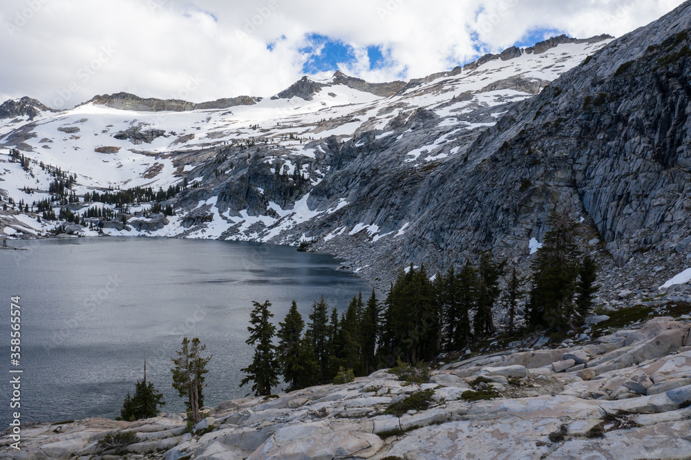 Snowmelt has filled a high mountain lake in the Sierra Nevada mountains in California. These scenic mountains, that rise between 5,000 and 9,000 feet, provide amazing wilderness areas for hikers.
