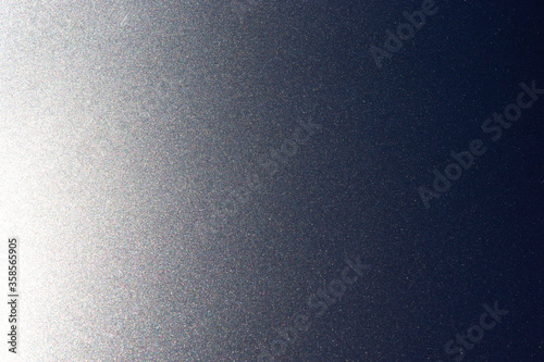 Shimmers on surface of metallic gray lacquered and polished metal background