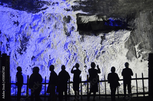 Tourists watching the wall covered in salt, nemocon salt mine, colombia photo