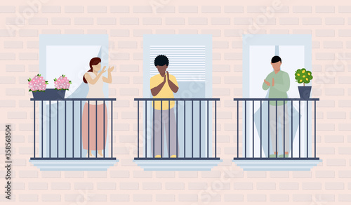 People applauding medical staff from their balconies. People clapping on balconies in support of health workers, doctors and nurses during the Coronavirus pandemic.