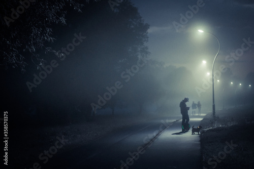 a man walks through a Park in a fog