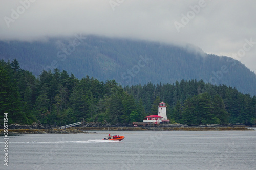 Sitka, Alaska, USA: A small lighthouse on an island in the waters off of Sitka, Alaska, under a cloudy sky. photo