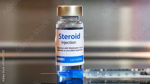 Bottle of steroid injection with a syringe photo