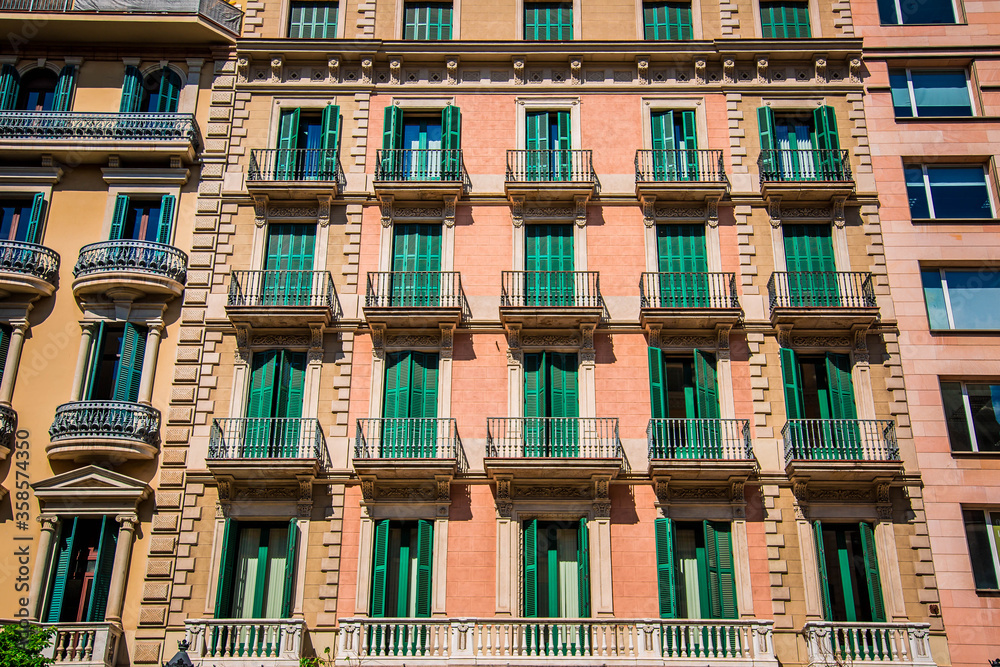 beautiful facades of traditional old historic spanish houses, windows and balconies, located in Spain.