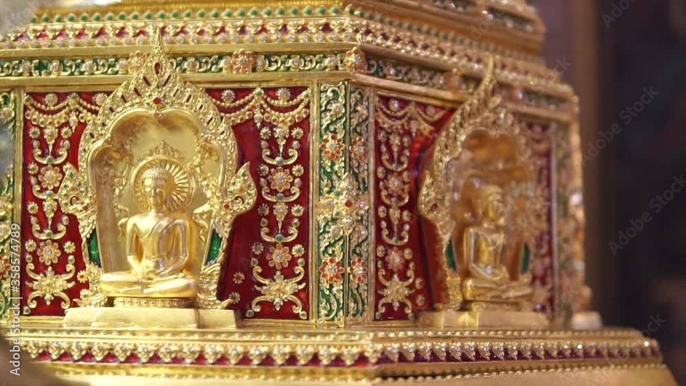Dhatu or sarira are small that look like pearls or crystals formed after the body is cremated after the death of Buddhist monks. Small golden and shiny buddha statue. Dhatu or sarira are small that look like pearls or crystals formed after the body is cremated after the death of Buddhist monks. Small golden and shiny buddha statue.
