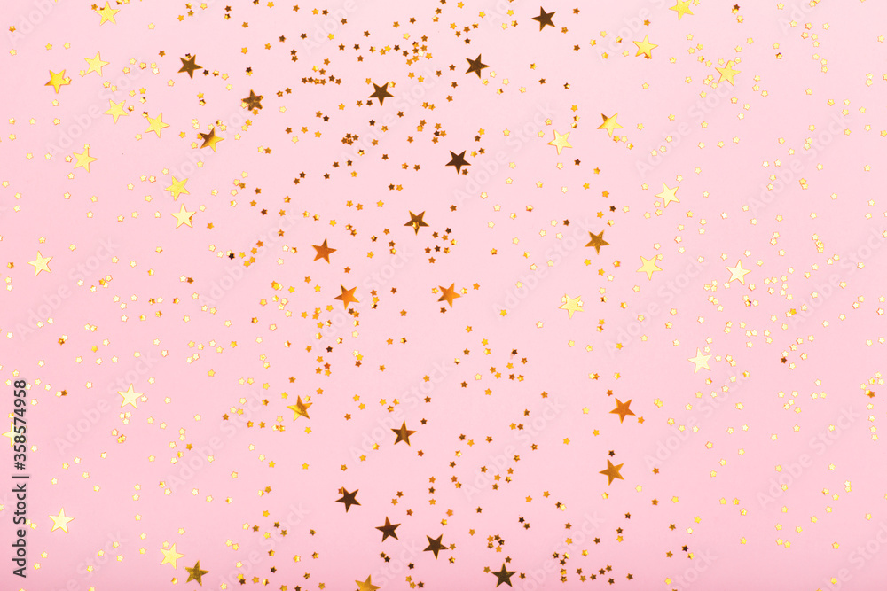 Falling star shape confetti on pink background. Perfect for festive and holidays projects. Copy space for your text.