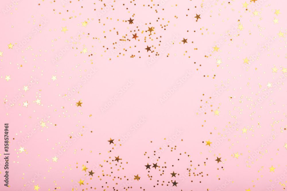 A border made with falling confetti on pink background. Perfect for festive and holidays projects. Copy space for your text.