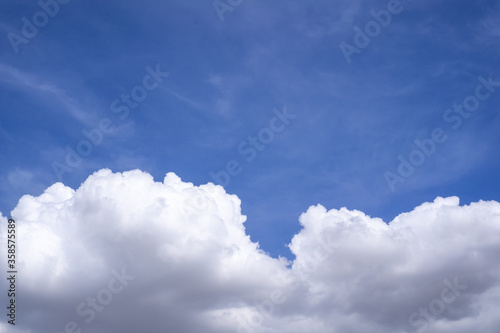 Large white clouds in the indigo blue sky