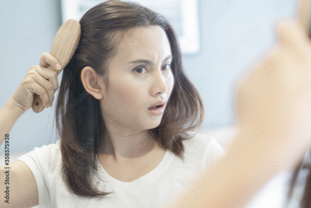 Woman serious hair loss problem for health care shampoo and beauty product concept, selective focus Woman serious hair loss problem for health care shampoo and beauty product concept, selective focus