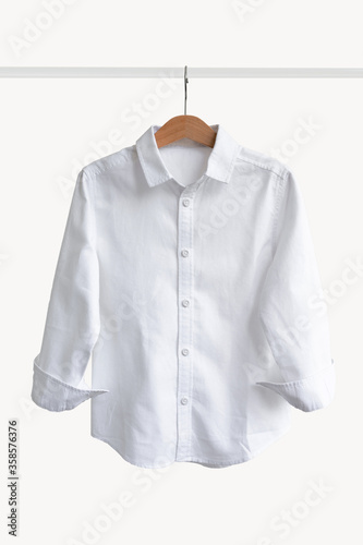 White shirt hanging on shoulders on a white background