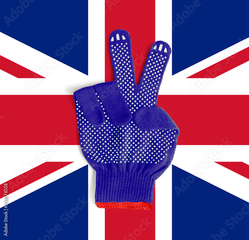 Construction gloves with a gesture of victory on the background of the flag of Great Britain