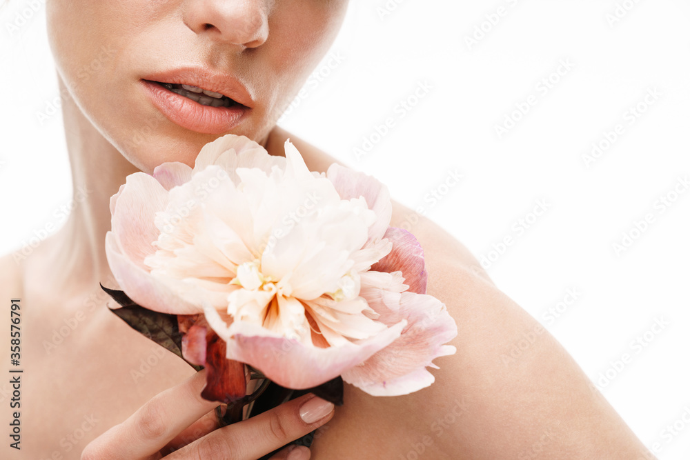 Image of beautiful caucasian young shirtless woman holding peony flower Image of beautiful caucasian young shirtless woman holding peony flower