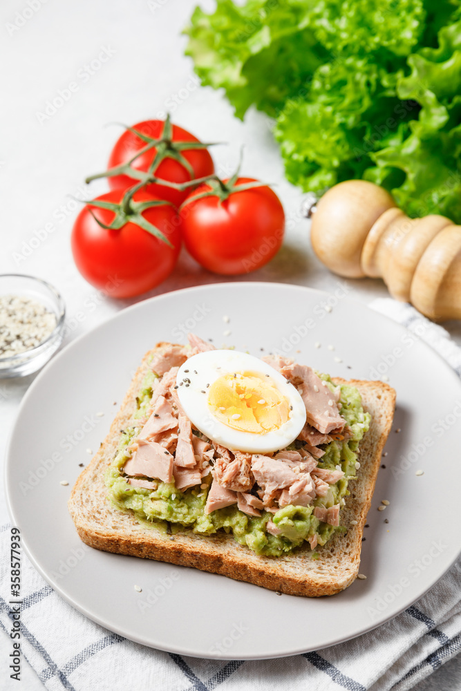 Avocado rye bread toast with tuna and boiled egg.