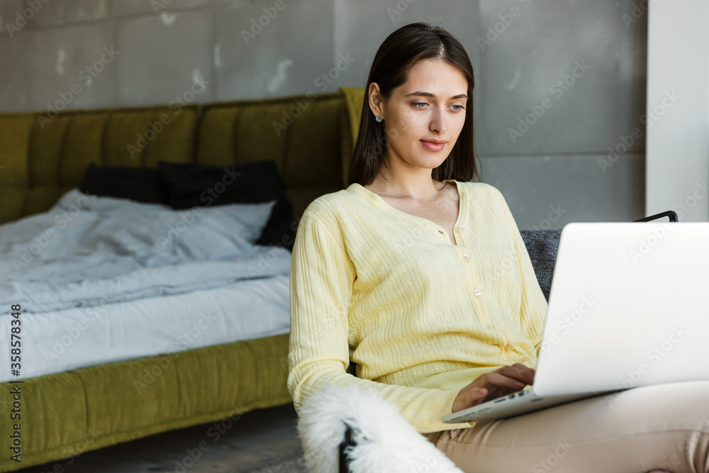Attractive young brunette woman using laptop computer Attractive young brunette woman using laptop computer