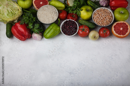 The concept of a healthy vegetarian food, rice products, chickpeas, vegetables and fruits on a light background. Food rich in antioxidants and vitamins. Copy spaes.
