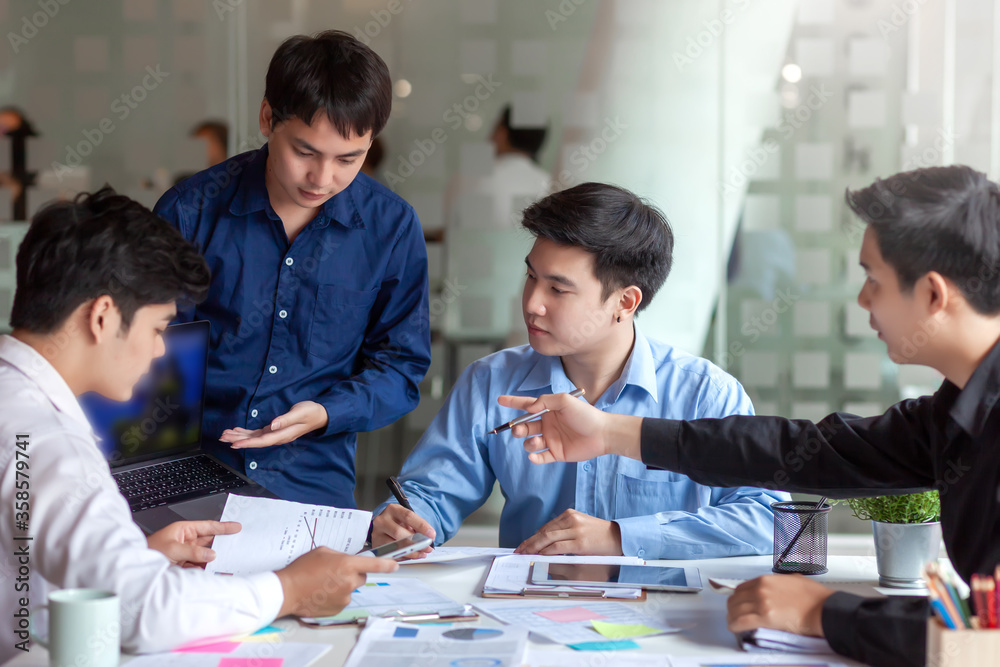 Meeting of young asian business people who are committed to work. Creative business team sitting working together at office. Meeting of young asian business people who are committed to work. Creative business team sitting working together at office.