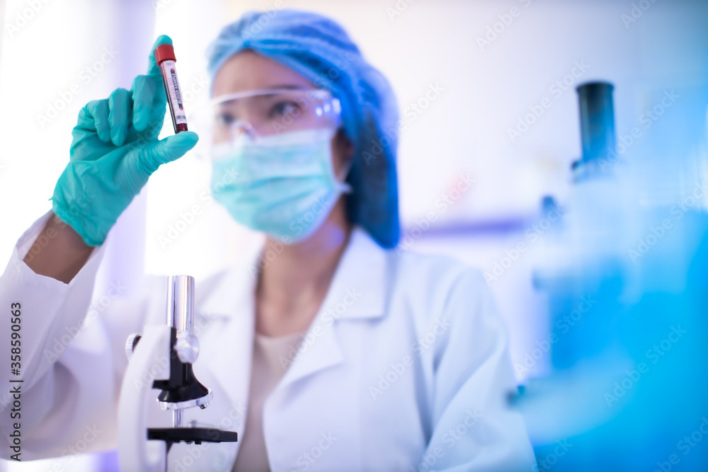 Fototapeta premium The scientist doctor created a vaccine against the coronavirus.Coronavirus 2019-nCoV Blood Sample. virus outbreaking.Technician holding blood tube test in the research laboratory