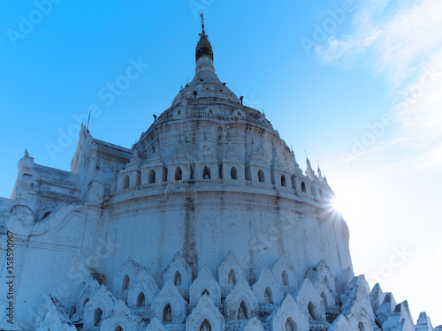 Hsinbyume pagoda, stunning white pagoda built in 1816 by Prince Bagydaw, as a memorial of his wife. The unique architecture followed Buddhist cosmology, Mount Meru as center and seven mounts around. photo