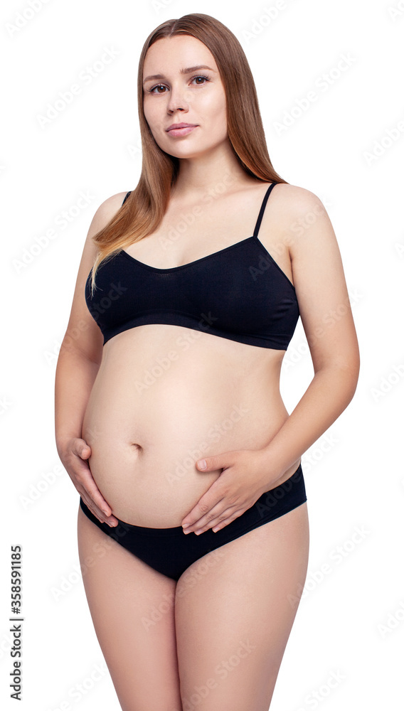 Pregnant woman touching her big belly in black lingerie. Pregnant woman touching her big belly in black lingerie.