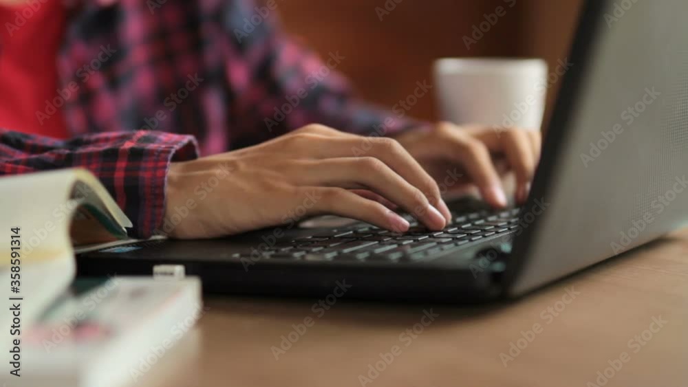 Hand of young asian student typing laptop computer keyboard, writing chat message with tutor while taking online class at home Hand of young asian student typing laptop computer keyboard, writing chat message with tutor while taking online class at home