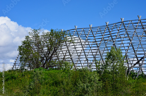 wooden stockfish structure on blue summer sky