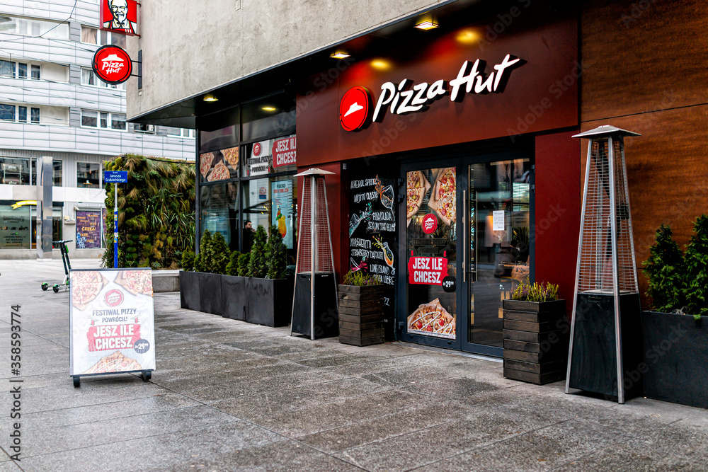 Warsaw, Poland - January 22, 2020: Pizza hut fast food chain restaurant and  nobody with logo sign by entrance near Centrum city center in Warszawa  Stock Photo | Adobe Stock