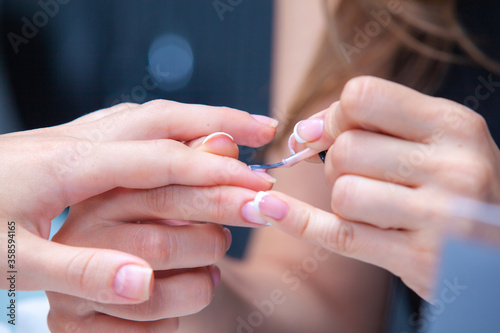master in the salon applies nail polish