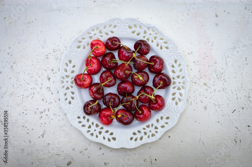 red cherries in a bowl, On a stylish white table